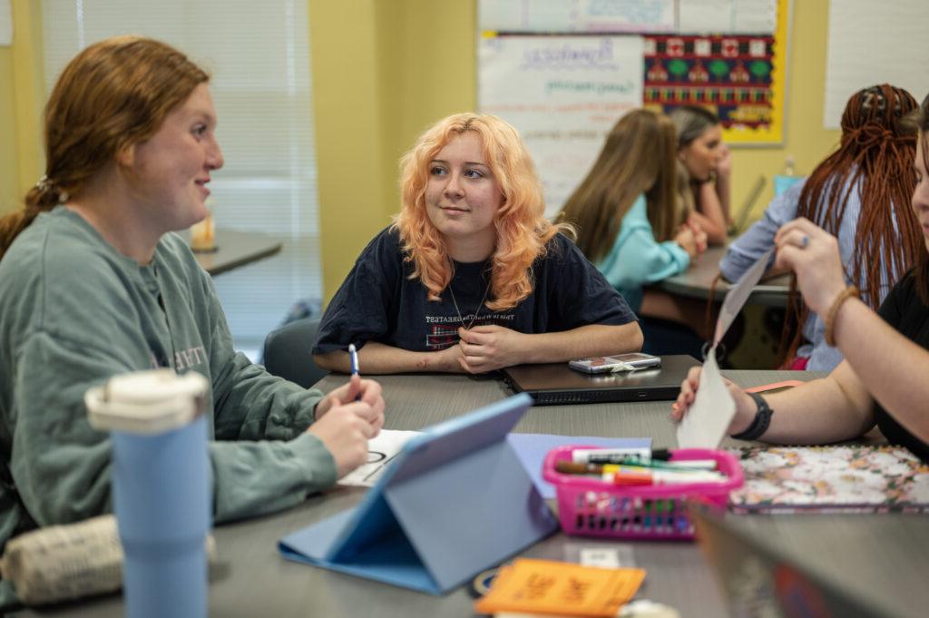 Students engage in discussion groups in class.